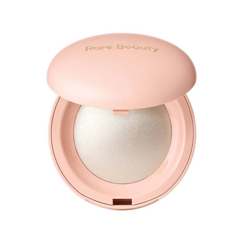 Compact powder with a pink lid featuring 'Rare Beauty' on a white background