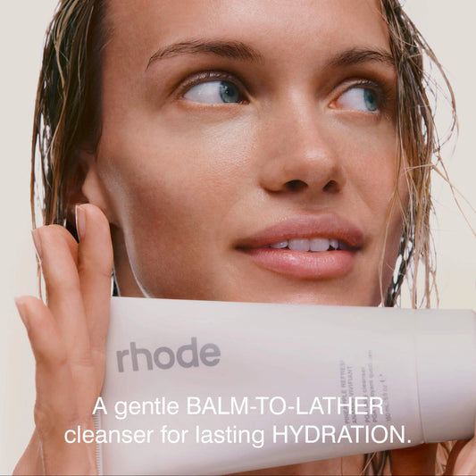 Woman holding a 'rhode' cleanser with text about hydration.