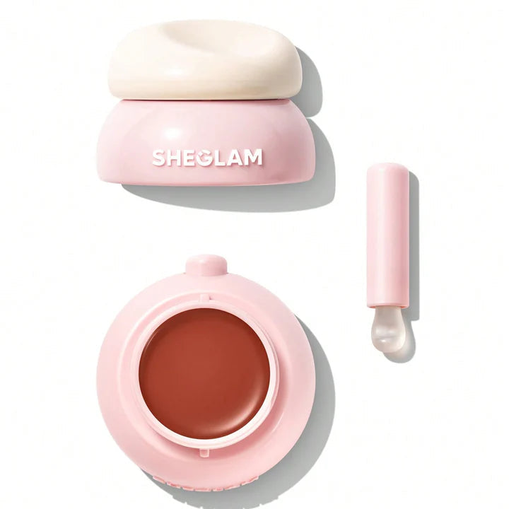 Sheglam cosmetic product with pink container and brown cream on a white background