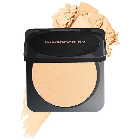 Huda Beauty compact powder with a black lid on a white background