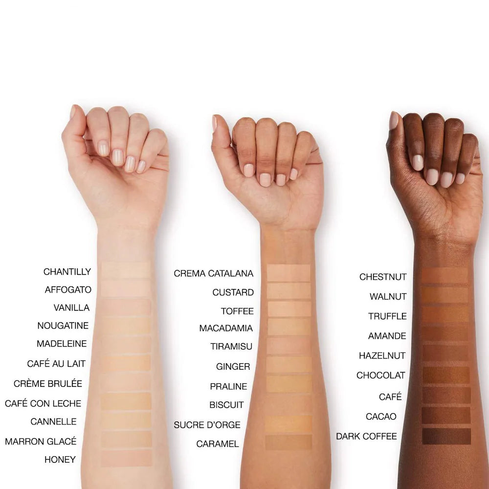 Three hands with different skin tones displaying makeup swatches labeled with various names.