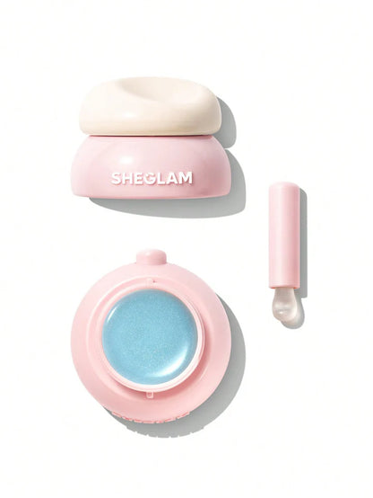 Pink cosmetic container with blue gel and applicator on a white background, featuring the brand 'SHEGLAM'.